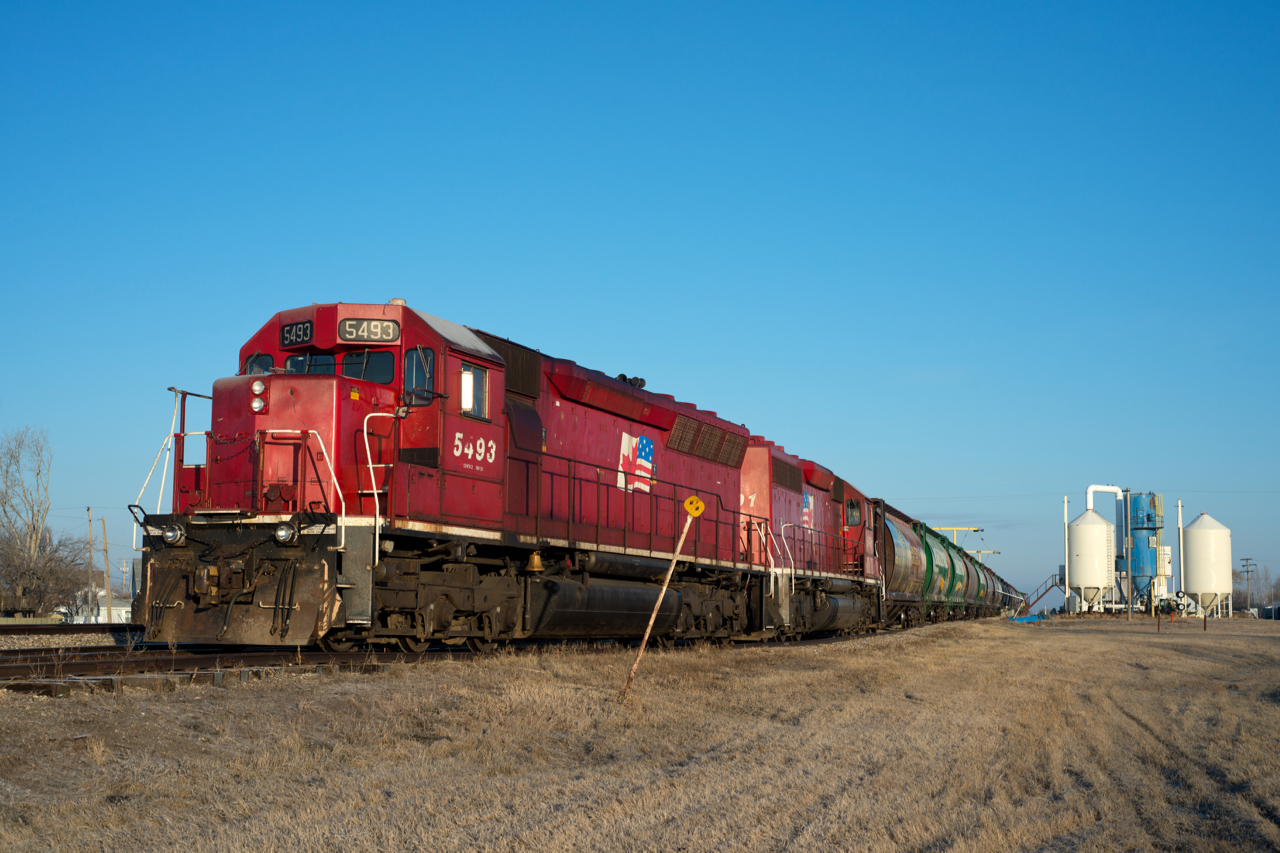 Two of Mobile Grain's yet to be repainted units sit tied down at Bethune Saskatchewan in some perfect morning light.