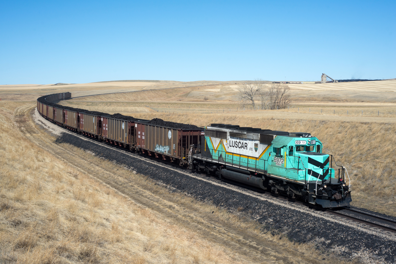PRMX 6972 is seen departing Westmoreland coal mine just north of Coronach Saskatchewan with a train of recently acquired exBNSF hoppers.