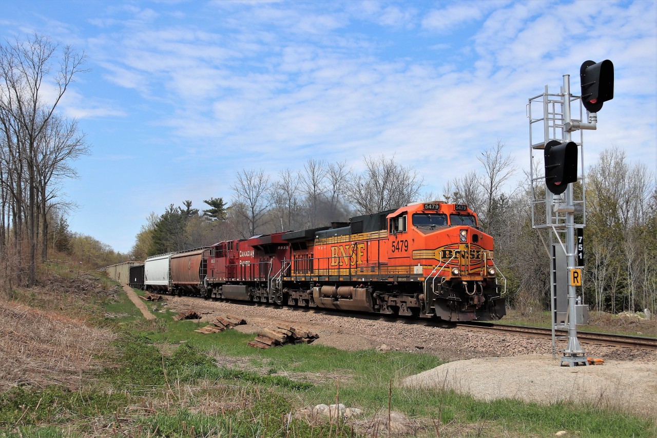 I got a text from a fellow railfan saying CP 254 was lined down the Hamilton sub. I had little to zero interest in going anywhere to see that same old same old. Unlike other times, this was a Monday so CP 254 usually goes down and back up the same day. Earlier in the day, BNSF 5479 was actually leading CP 244 which terminated so all thoughts of it coming were gone. I can hear CP254 blowing for the crossings at Emerald Lake and the Seventh concession and my grandson wanted to go see it. I get another text saying the BNSF is leading CP 254. Off we go and I know I have no chance to catch it on the Galt sub, so this spot, at this time of day is a beauty. Here BNSF 5479 with CP 8935 head down the Hamilton sub at mile 75.1 with a clearance to Welland. Fresh new ties, fresh new ballast and a slow order made this an easy chase down.