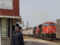 One can only imagine the generations of little railfans and their parents that have spent time under the shelter of the station overhang at Georgetown. If those old wooden walls and stone foundation could only talk, the stories they could tell. Today a few spare hours allowed for a trip through one of my favorite towns and a few photos. On arrival at the station my boys and I crossed paths first with VIA 86. A few minutes after its departure a green signal was lit for CN 394, soon a father and very young son arrived on bikes. As a parent fond memories soon filled my head as I watched the two bond over something that has given myself and my now older boys so much joy. While my boys worried the pair would get into their shots, I made sure they would make my shot. Railfanning for me in recent years has changed my focus as the motive power gets more same old, same old. It is nice from time to time changing the main focus of an image. I figured the motive power would most likely be run of the mill Gevos, and was right, so the father son combination certainly made the shot. It's always amusing watching small children cover their ears as the large locomotives storm past, but for some reason they never want to back away, taking it all in, and a toot from the horn always fills their eyes with excitement. What an amazing Hobby this is ! 
