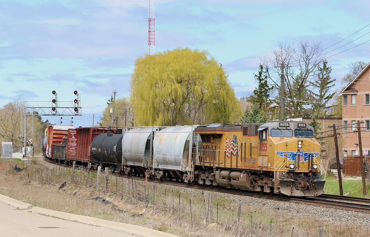 Shades of spring yellows are alive as UP Gevo 8055 passes a large willow tree coming alive east of Streetsville yard. The train has just finished working Hornby yard and is back on the move again, heading for Toronto.