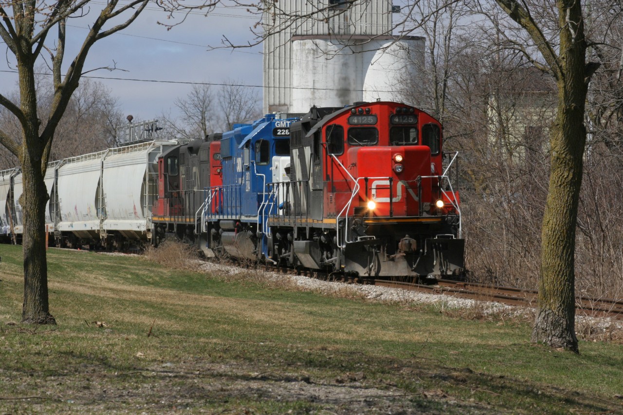 CN L540 has just crossed Queen Street in Kitchener on the Huron Park Spur. CN 4125, GMTX 2284 and CN 7081 are hauling a lengthy train to the interchange with Canadian Pacific. April 5, 2020.