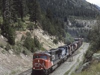 Eastbound CN 5688 with CR 740, CN 5188 and 5102 are at Conrad on CNs Ashcroft Sub. Conrad is just west of the bridges at Cisco.