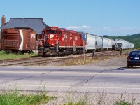 Nearing the end of CP's ownership of the Owen Sound Subdivision I decided to make one last trip to Orangeville. This time I was rewarded with a pair of repainted GP9U's, from almost the top and bottom of the 8200's list. The train has just arrived in town and is beginning to work the relatively full yard. My old Tercel sits to the right as a photo prop. The bunk house and boxcar would survive the OBRY takeover but are both long gone today. The old 40' boxcar sits where the old station once sat, and there was once a run around track located behind it. Today the station sits near downtown and is a popular restaurant.