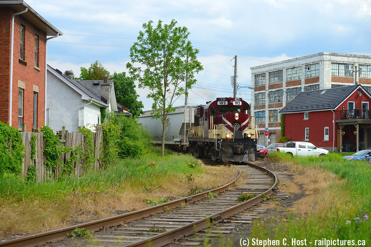 Job 2 has arrived in town and their first order of busines is to turn the train. Rounding the wye at Sackville and Alice St in Guelph, OSR RS-18 182 is taking the south leg so they can work PDI elizabeth st and Lower Yard on the Guelph Junction Railway. I came upon this scene and framed the Northern Rubber factory (formerly Chemtura/Uniroyal, now turning into Condos) and the nearby oddball houses into the shot. I had never framed it in quite this way before.