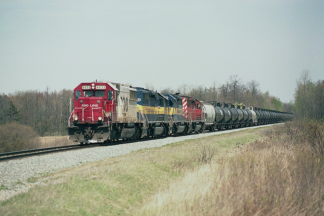 The rather short lived influx of oil trains thru Niagara brought a lot of photographers out while it lasted. These trains became almost regular at two a week, plus return empties; and suddenly they were gone. What can be seen along the Galt sub nowadays are not only less frequent, they also lack the interesting power of the SD40-2 lashups.
This is a typical run, as seen approaching mile 23 and the Welland Yard; SOO 6033, ICE 6444, 6419 and CP 5964.