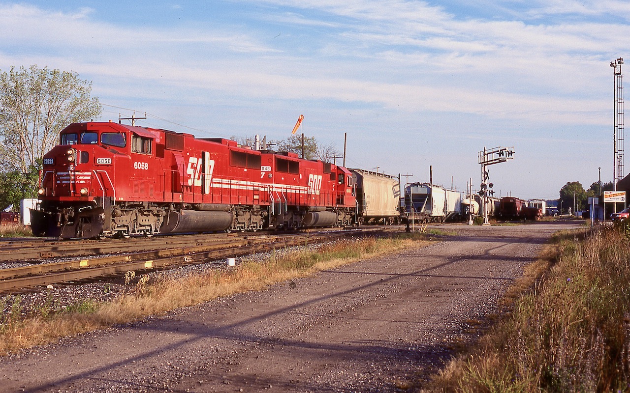 A pair of relatively clean SOO Line SD60's roll past Woodstock station, complete with a StL&H sign. Most of the traffic in the sidings appears to be for the potash facility in Putnum and will be lifted by one of CP's locals. Today OSR typically works these tracks as well as the entire St. Thomas subdivision.
