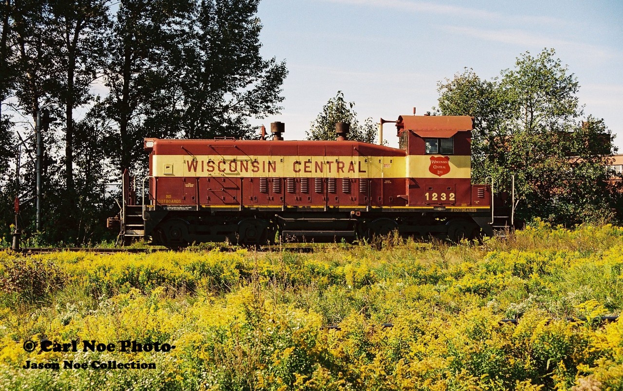 Wisconsin Central Railway SW1200 1232 is viewed switching the massive Algoma Steel facility in Sault Ste. Marie, Ontario that can be seen in the background. The unit was built as Missouri Pacific 1278 in February 1966 and still had its original EMD builder's plate intact.