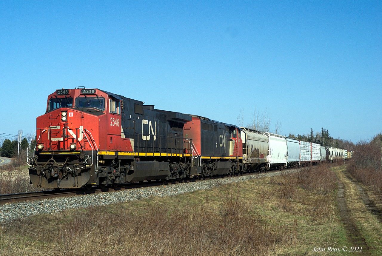 Thomson Station, MP 42.5, Springhill sub, east of Oxford,NS at 16:50 2021/04/15, more than 7 hours after the last train through here. Train 407 is the daily Halifax - Moncton mixed freight, which usually lifts traffic at Truro from CBNS. Today's version had the 2546 and 2449 for power.