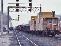<br>
<br>
   Westbound at Leaside Junction circa 1980
<br>
<br>
   ….' double tailed ' end of train devices...with CP Rail van 434337 holding the markers
<br>
<br>
   The original Leaside Junction consisted of one crossover to accommodate north track access to the Don Branch to/from the east.
<br>
<br>
   The Don Branch, to the left, commenced just beyond the second signal gantry, the south side storage tracks just west of the Don Branch switch.
<br>
<br>
   Beside the active dispatcher phone box, at the base of each of the gantry supports is the  'return-to-train'  push buttons to allow crews to have a 'restricting' signal for the respective route ( to accommodate 'the push' engine(s) ).
<br>
<br>
   At mile 206.3 CP Rail Belleville Subdivision, January 12, 1980 Kodachrome by S.Danko
<br>
<br>
   Interesting:  In the extreme foreground is part of the VIA era passenger kiosk platform. The west end of the steam era centre platform, between the south and north man tracks, extended almost a half mile well to the east of the existing former Leaside station building, commenced immediately to the right of the camera location. The centre platform was removed in the early 1980's at the time the welded rail installed.
<br>
<br>
   More Leaside
<br>
<br>
 <a href="http://www.railpictures.ca/?attachment_id=  6335">    Budds'     </a>
<br>
<br>
 <a href="http://www.railpictures.ca/?attachment_id=  45137">   eastward view     </a>
<br>
<br>

   