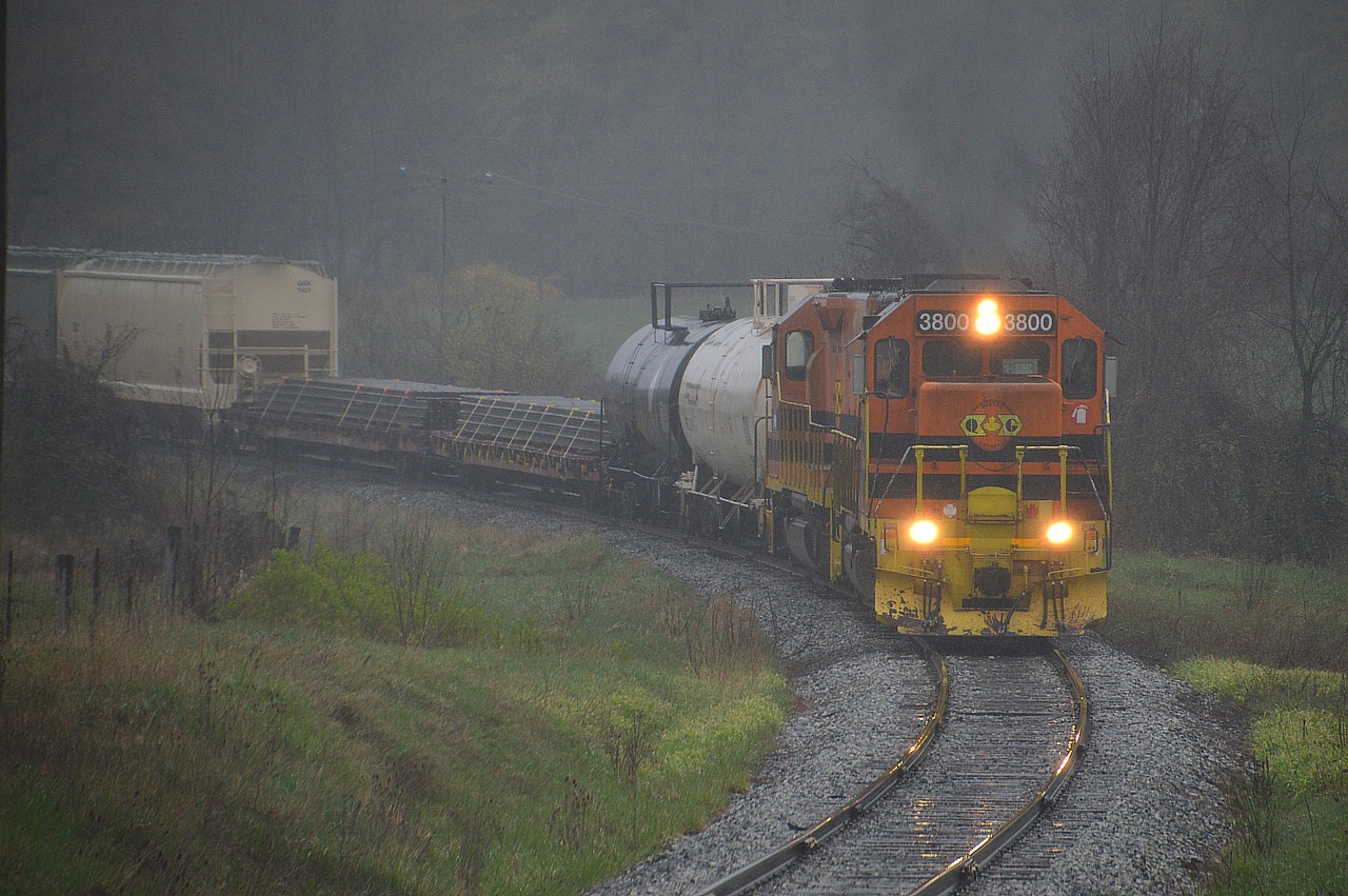 One more shot from a terrible weather day of the G&W running from Guelph Jct to Guelph in fog, rain, mist and generally just miserable conditions.  This image is of QGRY 3800 & 800 just out of Moffat, about to cross Concession 11......with Corwin the next hamlet en route to Guelph.  Pouring rain here.