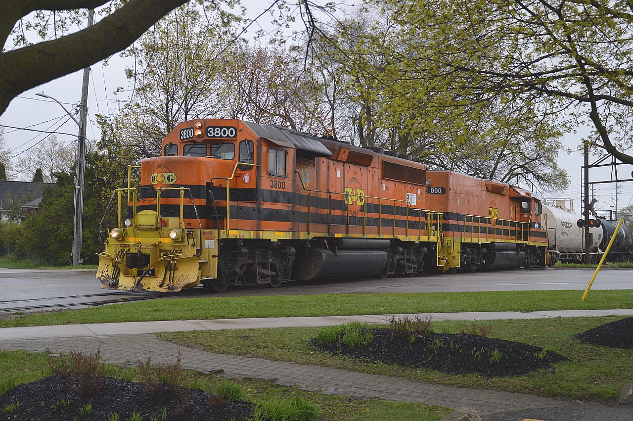 May the 4th be with me..........along with the fog and rain and whatever else dreary. But it still did not prevent me from following the old Guelph Jct Rwy; now under operation of the G&W. In this view, at a spot where  it was actually not raining, we see the Mother-daughter combo of GP40-3M 3800 and slug 800 (both lettered for the Quebec Gatineau) northbound crossing Woolwich St at Speedvale Av in downtown Guelph.  For me, something different. Good size train; maybe 15+ cars.