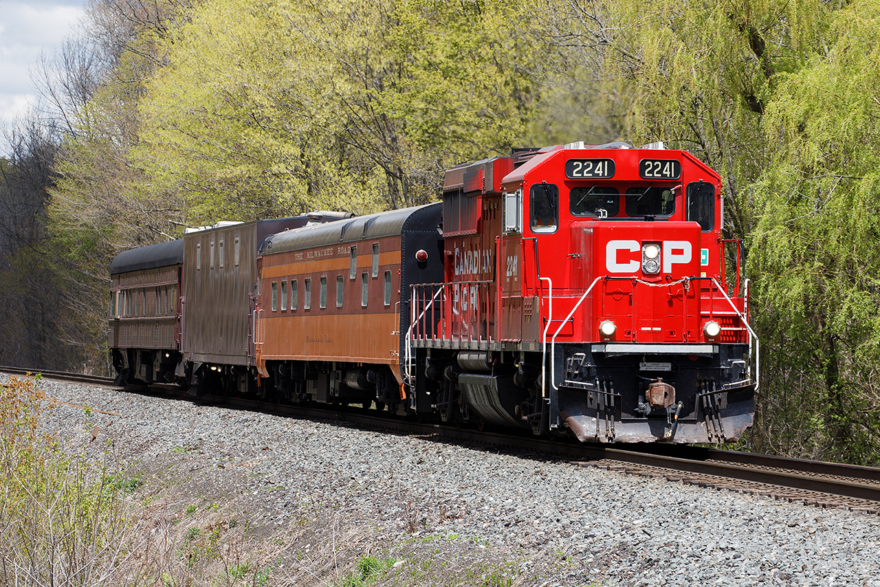 TEC train climbs Orr's Lake Hill on the west side of Cambridge....the Milwaukee Road car still a part of the package. But that bay window in the evaluation car....that's a place to sit and watch the world go by