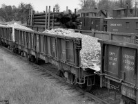 Loads of gravel, poles, snow plow, and caboose at Coquitlam yard