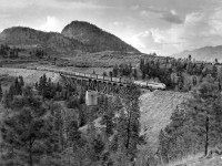 CPR's train # 12 with F.M. engine 4104 descending the 2.2% grade into Penticton from Kirton BC is seen here on the Trout Creek bridge at Winslow BC.  Lake Okanagan just over rise to right and below by about 300 feet.  Camera was a 4x5 speed graphic.  Royal Pan film ASA 200.  1/200 second at f/4.9
