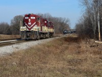 Propane season on the OSR - After just coming up from Tillsonburg, The St Thomas Job with the GP7’s have just cut their train preparing to make a lift at “Thomas Road” while the Woodstock Job pulls racks out of CAMI in the background. After the lift, the former SOO high hoods will then head to St Thomas for another day of switching propane and other customers under a sunny sky. Always great to hear motors built in the 50’s still doing work 70 years later. 