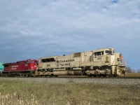 CP 119 crawls out of Vaughan IT with veterans unit CP 7021 leading a CP AC4400CWM rebuild. The conductor has just exited the cab and is standing on the front porch as the train eases east before turning north. 