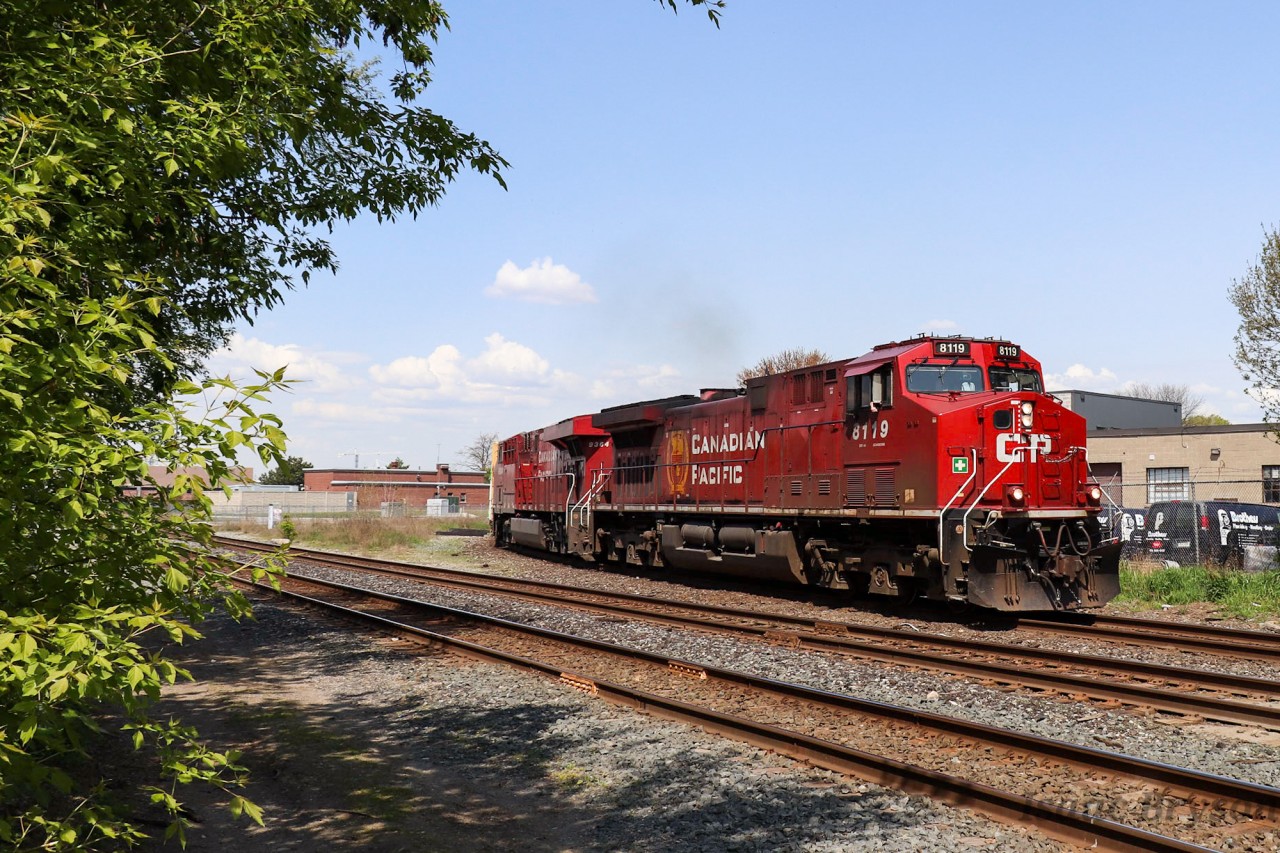Canadian Pacfic train 420 (Winnipeg-Toronto) glides around the curve at Osler Ave in Toronto with CP 8119 and CP 9364. A weeks worth of rain has helped the local flora as they get close to a "mid-summer green."