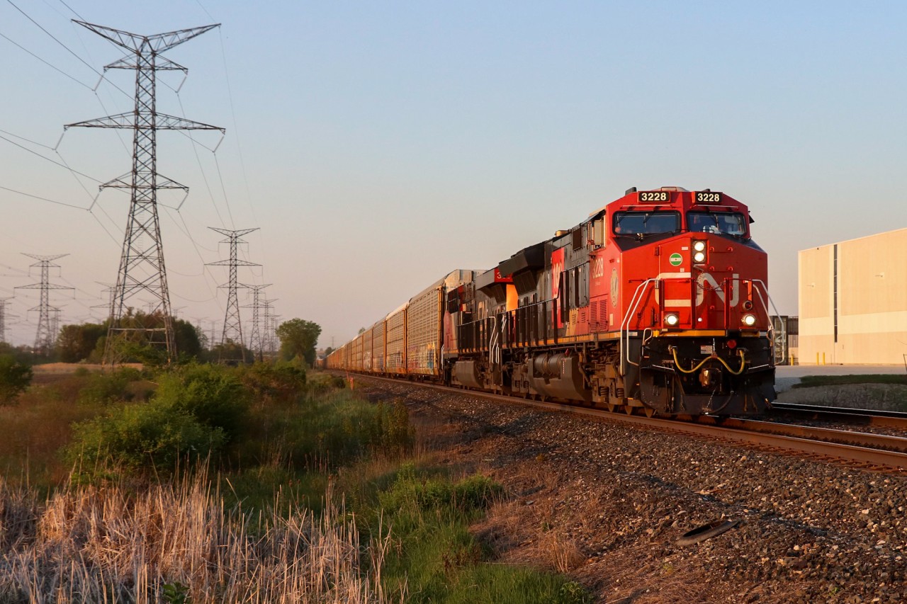 CP 2-241 races through the Hornby dip with 2 CN Gevos for power and a friendly engineer at the helm. 100 empty autoracks is no problem for the ET44AC/ES44AC pair as they reach speeds of 40MPH coming out of Mississauga and entering Milton. This train had originated in Montreal as a 9-119 so I was suprised when I saw them lined to Guelph Junction. To top it all off, an annoying cloud had lifted about 15 minutes prior, giving way to the setting sun and my favourite kind of light: golden.