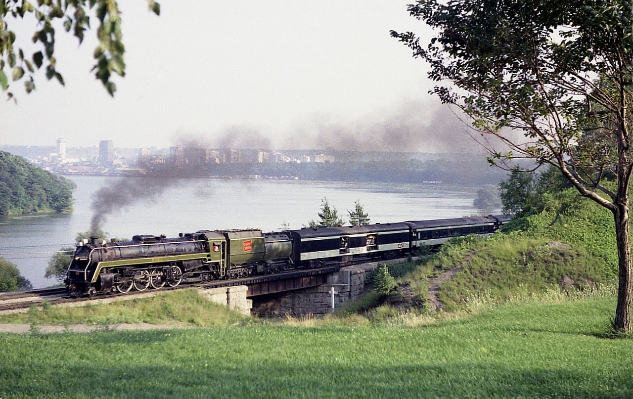 Good times while it lasted dept:   Wednesdays and Saturdays thru the summer, CN 6060 ran packed excursions from Toronto to Niagara Falls and back for tourists and fans in the mid 1970s.
Here's a late afternoon view of the train Toronto bound as seen from the parking lot of the Royal Botanical Gardens, Hamilton. Initially the train ran Saturdays only beginning in 1976.....retired in 1980.