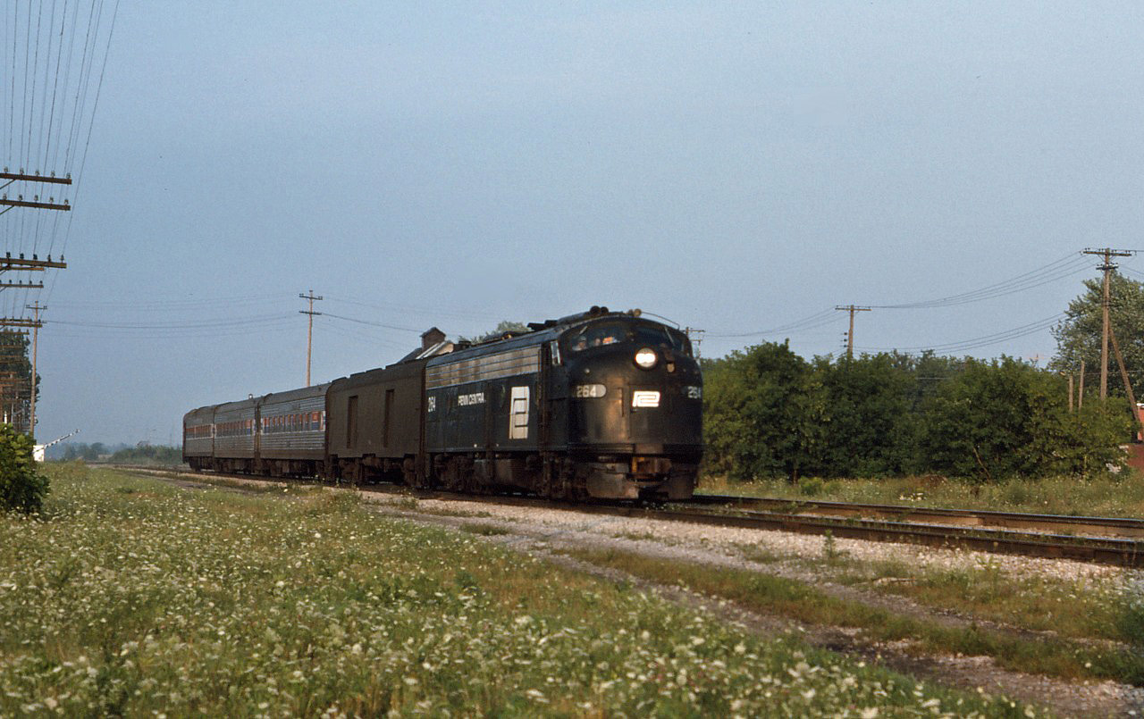 Former Penn Central E8 264 leads Buffalo-Detroit train 63 across the Canada Southern in the summer of 1975. 
This service ran across southern Ontario from October 31, 1974 to January 31, 1971.Of extra interest is the baggage car still in NYC colors. (U.S. spelling since we are talking about Amtrak here!)