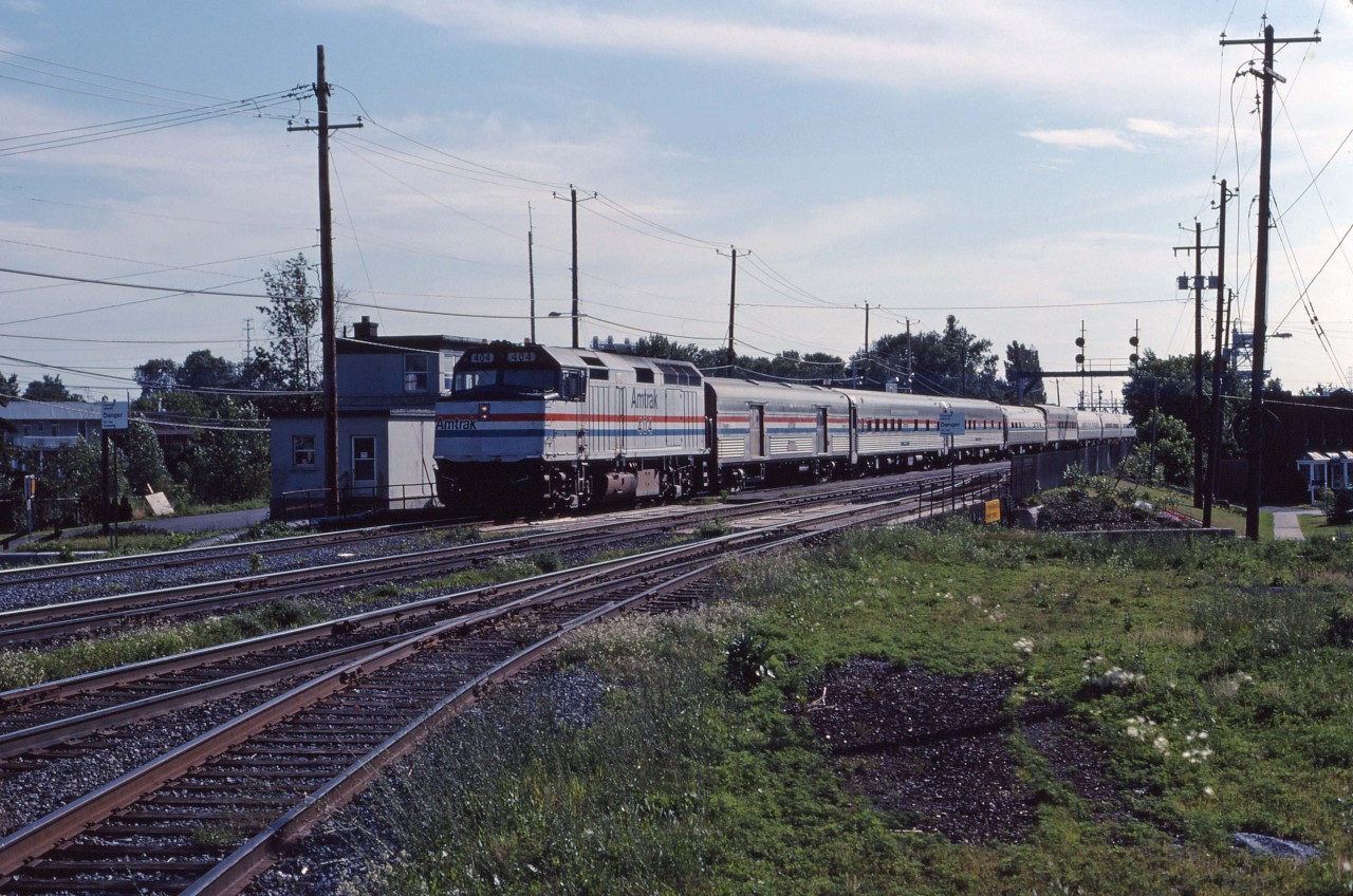 One of Amtrak's trains with an "on again, off again" history is the Montrealer. Initially begun in 1972 (first southbound trip was September 30th), the train was suspended between April 1987 and July 1989 due to slow timing over Guilford track. Once restored, it ran on its overnight schedule for almost another six years before changed to a day train and originating at St. Albans, Vermont on April 1, 1995. Apparently the Montrealer was the first train to use Amtrak on-board personnel because there weren't any holdover staff from its private railroad predecessor. Here we see the southbound train making its first stop on its way to Washington at the Montreal suburb of St-Lambert behind F40PH 404.