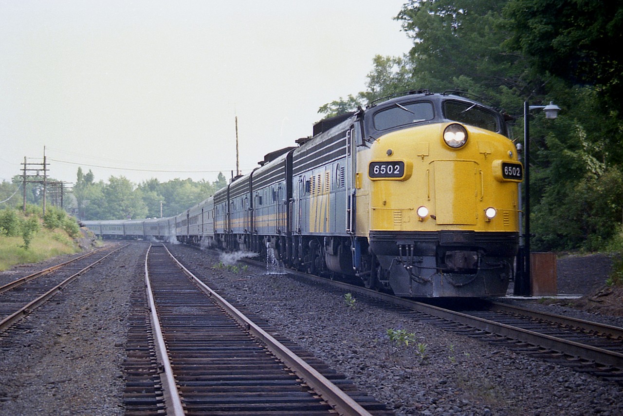 A rather healthy looking northbound 'Canadian', Toronto section stops at the CP station for passengers and servicing. Power is VIA 6502, 6610, 6612 and 6635.
Today the passing track is no longer, as well as the small yard out of sight at the left and the rather tired looking MoW siding.