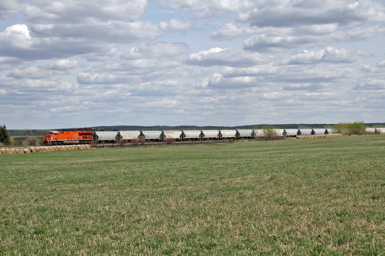 CN S 77381 12 rolls through the prairie farmland as they approach Edmonton, with a sand train from Wisconsin.