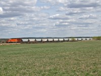 CN S 77381 12 rolls through the prairie farmland as they approach Edmonton, with a sand train from Wisconsin.