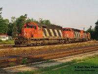 The early summer morning shadows have just receded far enough to allow for a view of CN Edmonton-Toronto train 304 curving through the village of Washago as it’s seen completing the final leg of its trip to MacMillan yard. Powering the southbound are CN 5053, 5241 and 5187.
