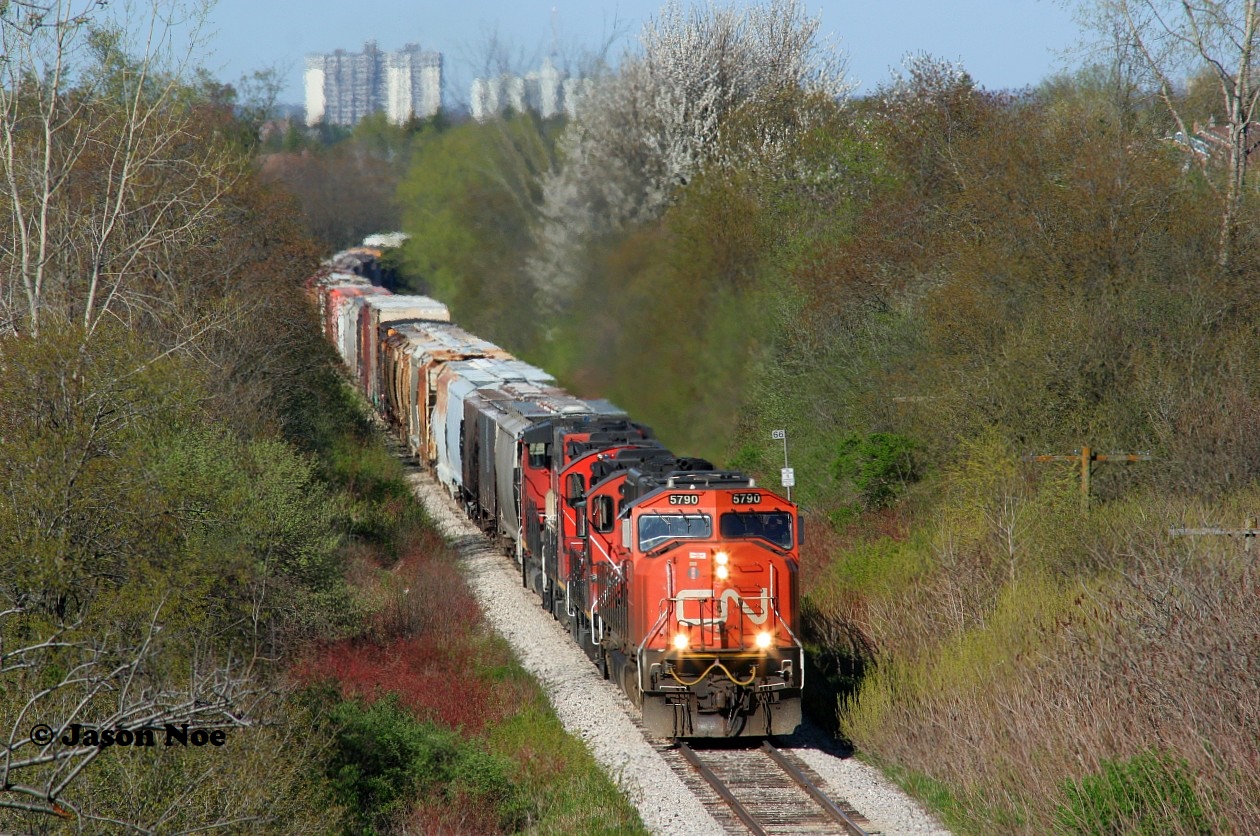 CN L568 is on its knees getting over 80 cars up the hill as it departs Kitchener, Ontario on the Guelph Subdivision heading to Stratford. The consist included; 5790, 4136, 7083 and 4790. May 20, 2020.