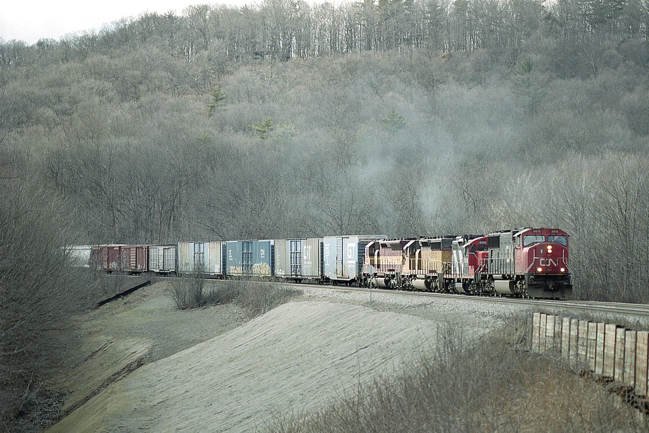 Bit of a hazy day; sun was called for, but it was busy along the hill at Dundas Mile 2. Drifting down is CN 5615, 4114, UP 7893 and WC 7495 as train #382.  CN did a lot of shoring up along here in the previous year and the landscape was still barren, making for some good angles. And better the next year when some vegetation filled in the hillside, but now, like many places that used to open, this location is a lost cause for photography.