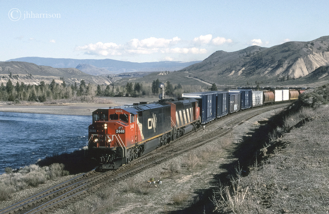 CN 2448 and 5536 are westbound at Basque on CNs Ashcroft Sub. There's a two way connection here between the CN Ashcroft and CP Thompson Subs. The crossover is used regularly due to directional running (since 1999) required to and from the coast via the Thompson and Fraser Canyons. This connection / crossover is listed as a directional running boundary. Eastbound routes beyond this point split up again at Savona and run either side of Kamloops Lake.
