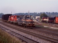 The morning hours were once the best time to be at Guelph Junction. Typically 3 eastbounds and any OSR action kept thing relatively busy. The berm was one of my favourite spots to catch the action. A lot has changed here from the removal of some tracks to the elimination of the access road to the Guelph Jct. Railway shop. This morning OSR was working Goodfellow and assembling their northbound train as CP "Sprint" frame train 142 clears the OCS with a GP40/GP38 combo. Good times!