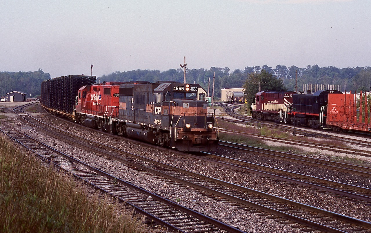 The morning hours were once the best time to be at Guelph Junction. Typically 3 eastbounds and any OSR action kept thing relatively busy. The berm was one of my favourite spots to catch the action. A lot has changed here from the removal of some tracks to the elimination of the access road to the Guelph Jct. Railway shop. This morning OSR was working Goodfellow and assembling their northbound train as CP "Sprint" frame train 142 clears the OCS with a GP40/GP38 combo. Good times!
