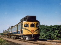 One of a kind streamlined doodlebug CNR D-1 rattles through Bayview Junction headed for the Milton Sub as train 660 from Hamilton to Allandale, becoming train 661 at Georgetown.  It will continue along to Meaford as train 61.  The return trip will operate as train 62 Meaford to Allandale, 662 Allandale to Georgetown, and 663 Georgetown to Hamilton.  If operating on time, one could make the 144-mile round trip in 12 hours and 25 minutes.  A <a href=https://s3.amazonaws.com/content.sitezoogle.com/u/131959/be01d7640a4b6fdf38835a67edada04862c7bc15/original/cnr-tt-57-80-to-99.pdf?response-content-type=application%2Fpdf&X-Amz-Algorithm=AWS4-HMAC-SHA256&X-Amz-Credential=AKIAJUKM2ICUMTYS6ISA%2F20210516%2Fus-east-1%2Fs3%2Faws4_request&X-Amz-Date=20210516T010630Z&X-Amz-Expires=604800&X-Amz-SignedHeaders=host&X-Amz-Signature=447098cf4afeda066c7d6cf76a4b741762cce810205fb0065f6cf6ca8a01d57c>1956 timetable (page 8)</a> lists the northbound trip as having a 0730h departure from James Street station, arriving Allandale at 1115h before departing for Meaford at 1145h with a 1350h arrival.  Departing Meaford at 1415h, the train returned to Allandale at 1610h, departing for Hamilton at 1635h and arriving at 1955h.  Passenger service on the line ended during 1960.<br><br>Originally constructed by Canadian Car & Foundry as <a href=http://www.trainweb.org/oldtimetrains/photos/cnr_self-propelled/15834.jpg>oil-electric CNR 15834</a> in 1926, the car would be converted circa 1951 – 1952 from a typical combine with baggage and passenger seating to an all baggage car to be used with two trailers, C-1 and C-2.  <a href=http://www.trainweb.org/oldtimetrains/photos/cnr_self-propelled/C-1.jpg>The C-1 served</a> as a combination RPO car with a seating section for passengers and featured a letter slot used during station stops, while <a href=http://www.trainweb.org/oldtimetrains/photos/cnr_self-propelled/C-2.jpg>trailer C-2 carried</a> strictly passengers.  The paint scheme seen above was applied sometime between 1956 and 1958 (stay tuned, the original scheme will be posted soon) and at the same time included the addition of the centre cab window and the dual sealed beam headlights installed overhead rather than the old “barrel” type.<br><br>More of train 662:<br><a href=http://www.railpictures.ca/?attachment_id=25498>At Caledon East, June 1960</a> by Ian MacDonald.<br><a href=http://www.railpictures.ca/?attachment_id=24668>At Inglewood with conventional equipment, July 1960</a> by Clayton Morgan.<br><a href=http://www.railpictures.ca/?attachment_id=25499>At Stewarttown, June 1960</a> by Ian MacDonald.<br><br><i>Original Photographer Unknown, Al Chione Duplicate, Jacob Patterson Collection Slide.</i>