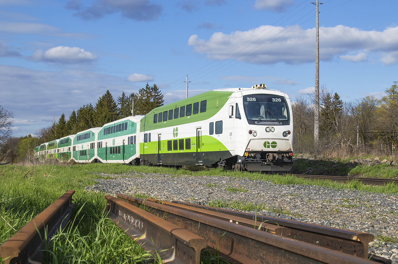 After departing Acton GO 10 minutes prior westbound GO train 3925 scoots across Wellington Road 29 approaching Guelph.