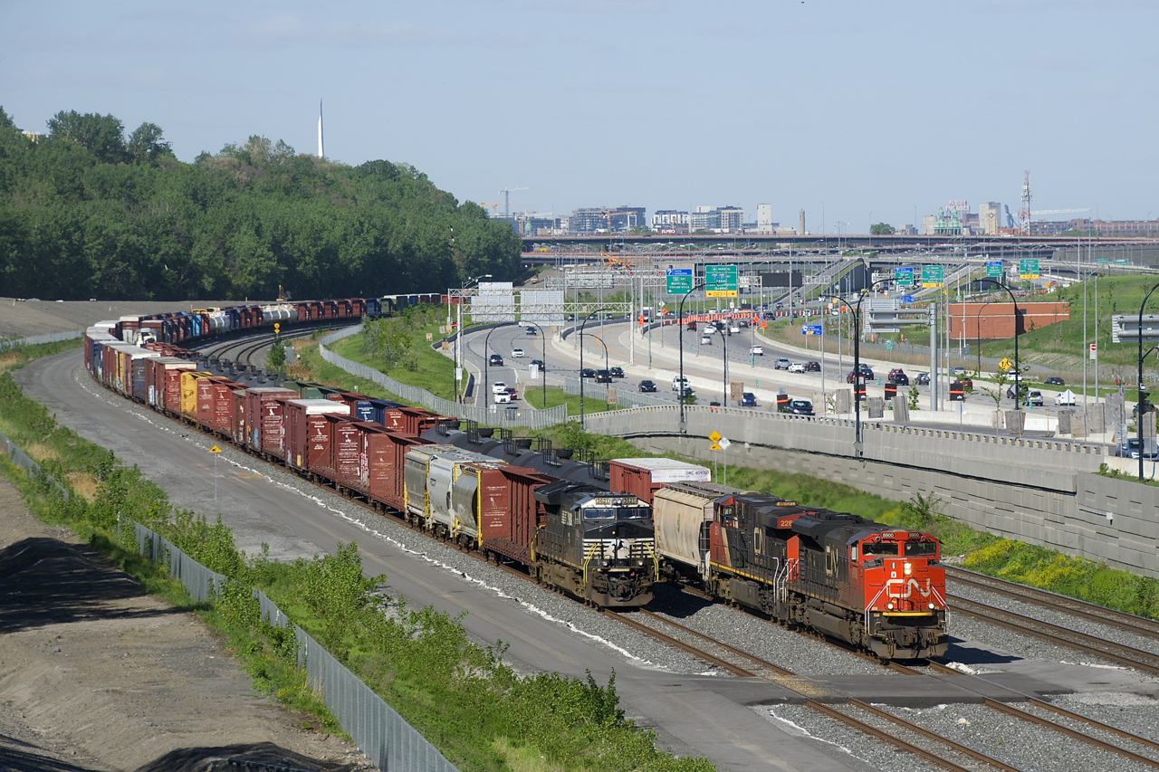 CN 323 is on its way back from Vermont with CN 8900 and CN 2284 for power as it passes a parked CN 529 which has NS 3621 as its sole power.
