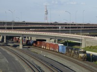 NS 7322 & NS 7548 lead CN 59-car CN 529 out from under the rebuilt Turcot interchange during some nice evening light. I was glad an SD70ACU was leading, as NS has already disposed of 46 out of the 110 versions of this rebuilt model.