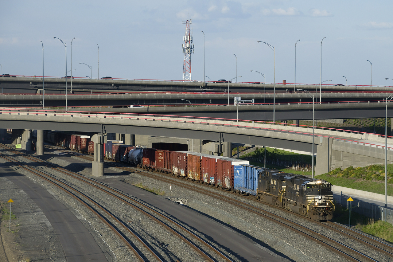 NS 7322 & NS 7548 lead CN 59-car CN 529 out from under the rebuilt Turcot interchange during some nice evening light. I was glad an SD70ACU was leading, as NS has already disposed of 46 out of the 110 versions of this rebuilt model.