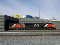 CN 120 is emerging from a tunnel under the newly rebuilt Turcot interchange as it heads east on the freight track of the Montreal Sub. Up above is the McGill University Health Centre, which is located on the site of CP's Glen Yard.