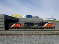 CN 120 is emerging from a tunnel under the newly rebuilt Turcot interchange as it heads east on the freight track of the Montreal Sub. Up above is the McGill University Health Centre, which is located on the site of CP's Glen Yard.