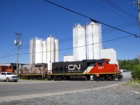 A conductor is finishing flagging Place Turcot as the Pointe St-Charles Switcher leaves the Kruger plant with CN 4721 & CN 4774 for power.