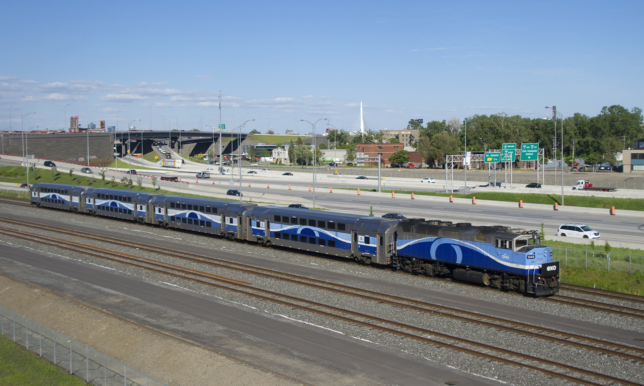 EXO 1211 is approaching the hot box detector at MP 4.8 of CN's Montreal Sub with AMT 1345 and four multilevel cars.