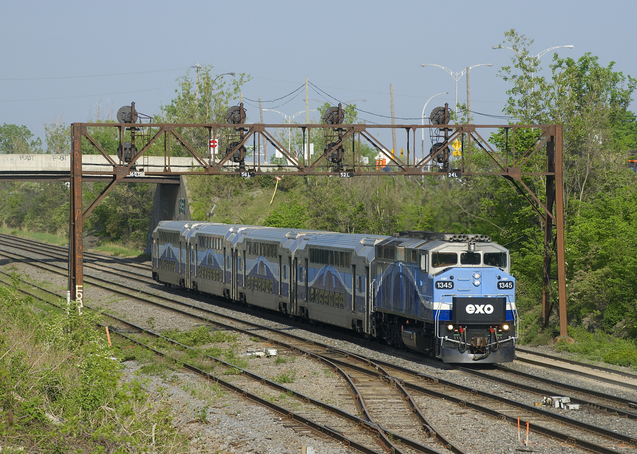 EXO 1211 is almost into Taschereau yard as it prepares to cross over from the north to the freight track. Since the closure of the Mount Royal tunnel last spring (due to work for the REM light rail project), these trains going to Mascouche from downtown Montreal take the long way around Mount-Royal, including crawling through Taschereau Yard at 15 mph.