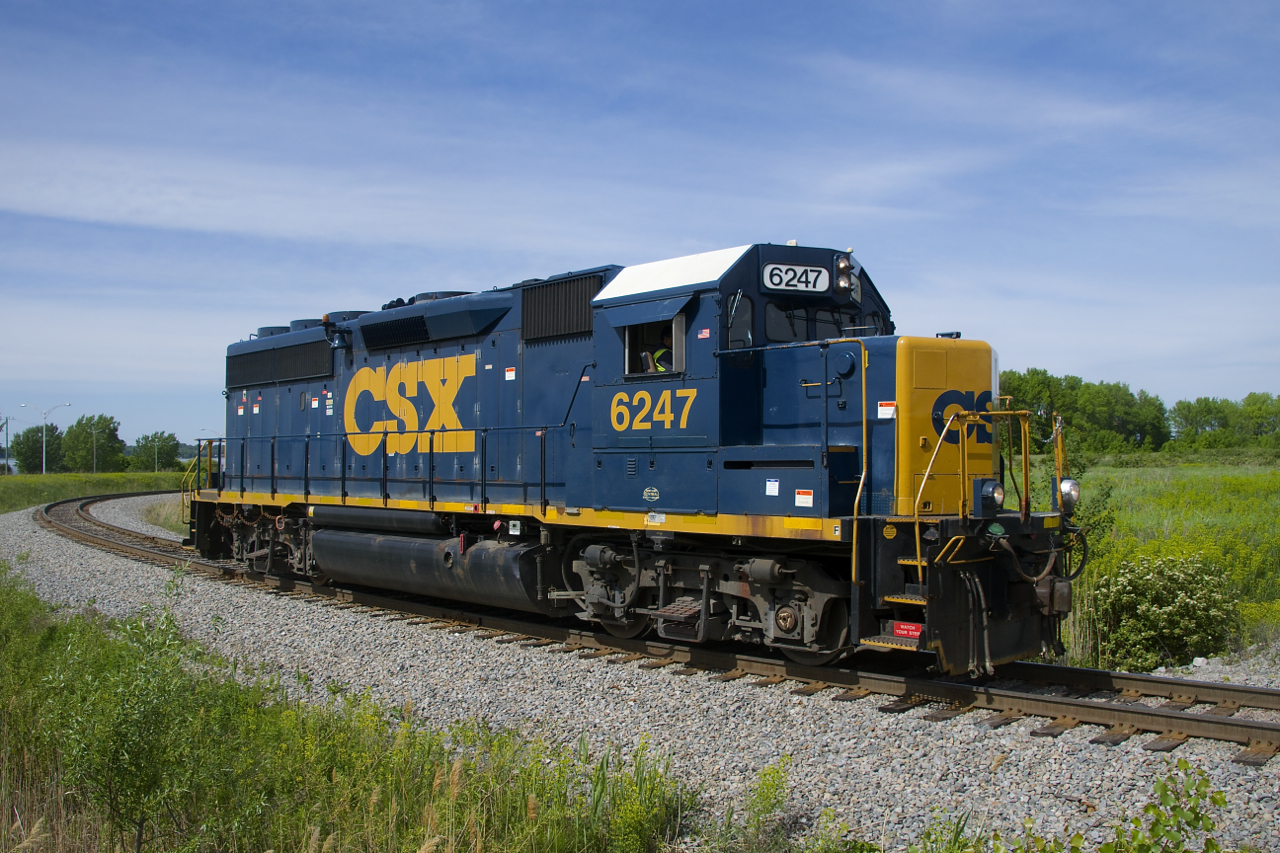 CSXT 6247 has left the Transflo facility in Beauharnois at the start of CSXT B786's shift as it heads towards the main line. Underneath the side window is a logo of some kind saying 'New York Central Boston & Albany'.