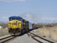 CN 327 is approaching CSXT Diageo with CSXT 485 & CSXT 214 for power. The crossing at far left is where main line used to go. it is now only used to serve Diageo distillery. At right is the north leg of the wye that leads to CSX's now abandoned intermodal terminal in Valleyfield.
