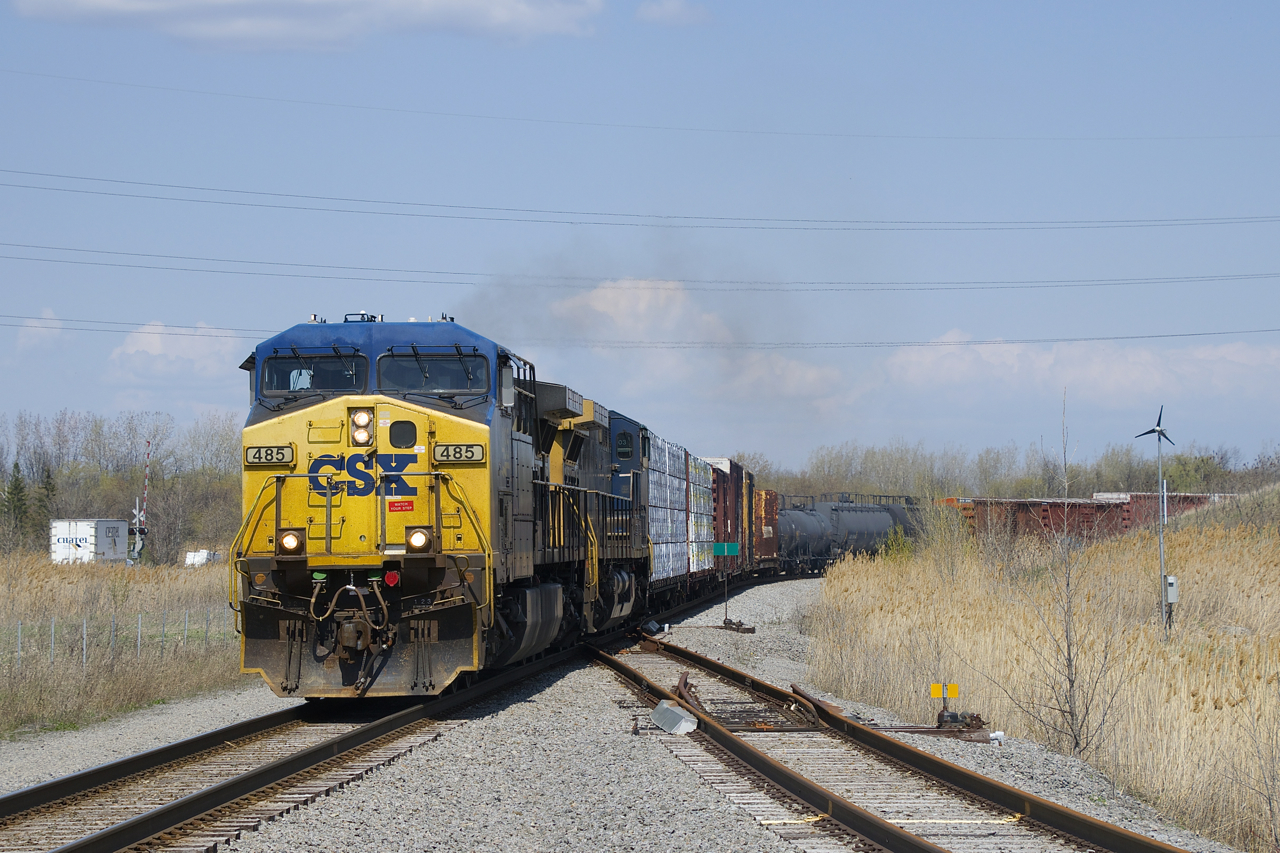 CN 327 is approaching CSXT Diageo with CSXT 485 & CSXT 214 for power. The crossing at far left is where main line used to go. it is now only used to serve Diageo distillery. At right is the north leg of the wye that leads to CSX's now abandoned intermodal terminal in Valleyfield.