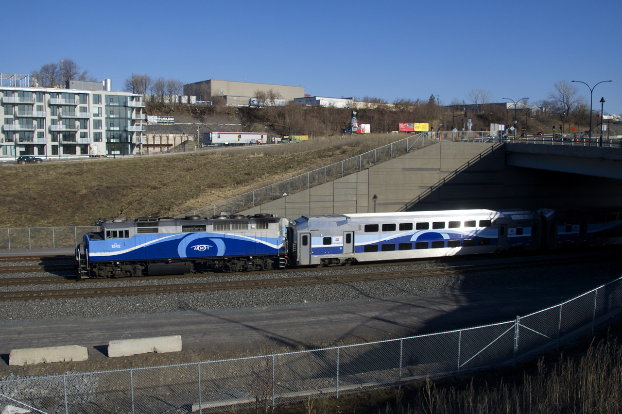 A cab car is leading and AMT 1342 is shoving as EXO 1202 from Mascouche ducks under an overpass.