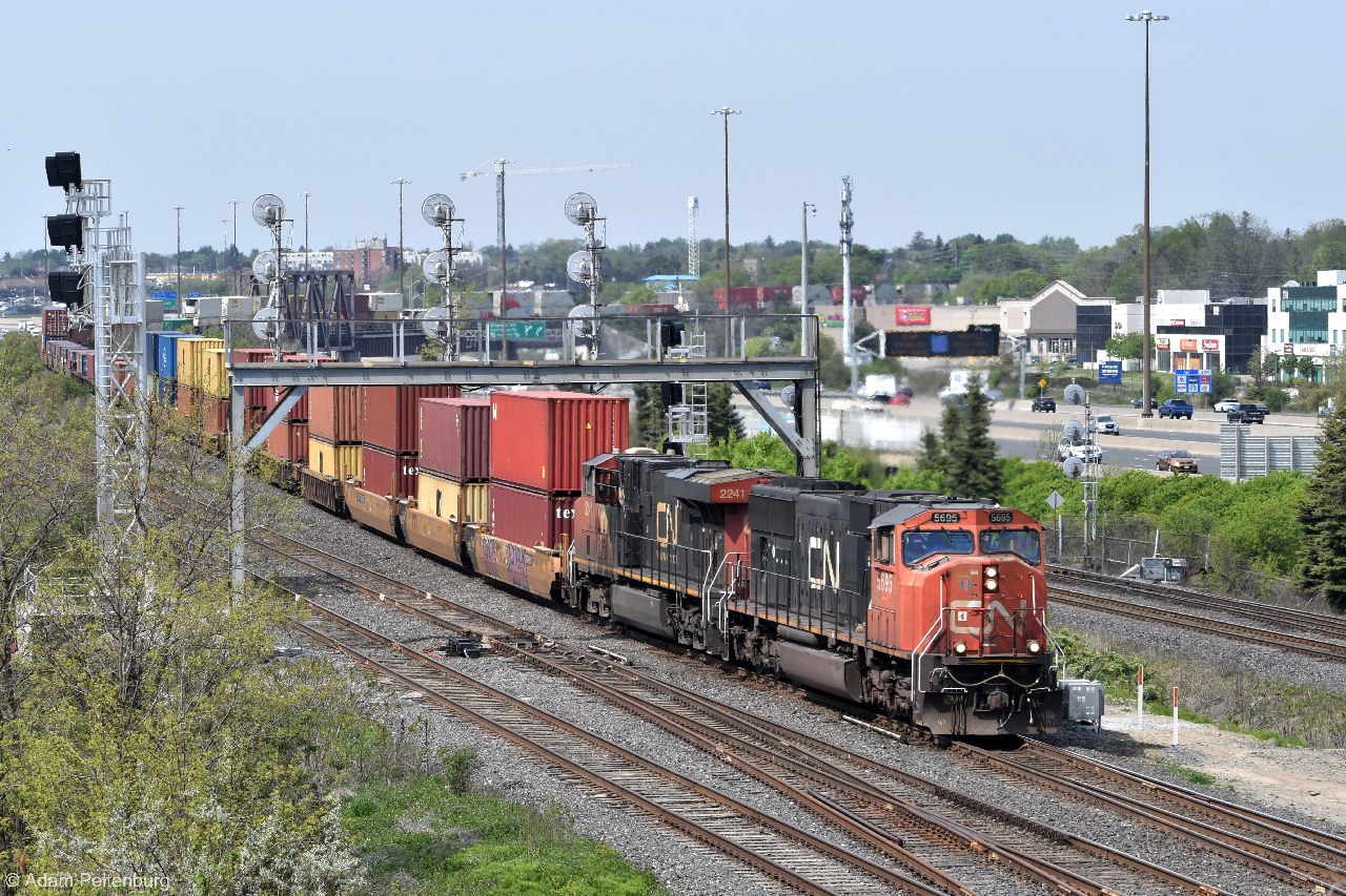 After slowing down to as much as 25 miles per hour while descending the steep grades of the York Subdivision, CN Q108 picks up speed before joining the Kingston Subdivision. The Liverpool searchlights are still standing tall as of this post, despite its future replacements being in place since the end of last year. I thought I had lost my chance by waiting this long to go back there, so I'm glad I was able to get this shot of them in time.